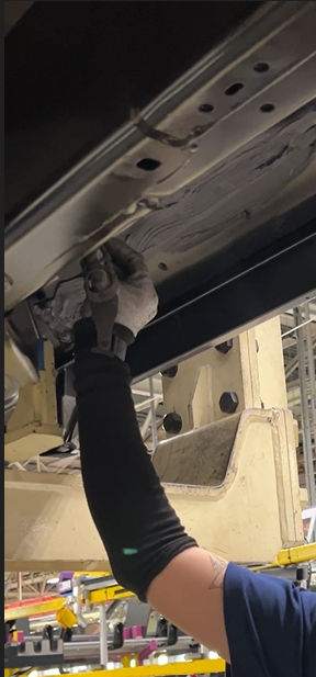 Close-up of the ARTUS exoskeleton on an assembly line